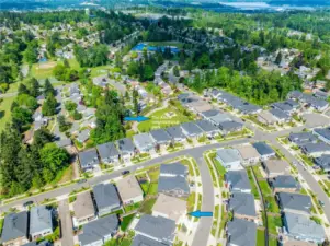 Excellent location and only a few minute walk to the big Allura neighborhood park with wide gravel walking paths, spacious flat grassy areas and picnic tables.  High-quality play structure with three slides, a climbing wall and multiple climbing and play stations.