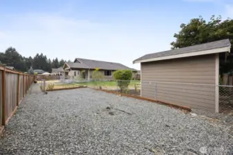 Fenced RV/Boat parking with separate access gates and storage shed