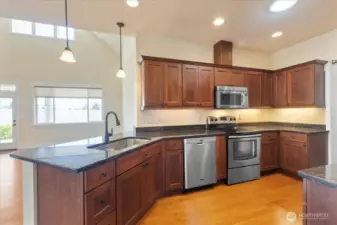 Showcasing luxurious granite countertops and high-end cabinetry, this beautifully designed kitchen offers both style and functionality.