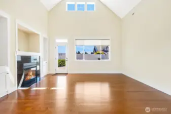 Cozy up by the gas fireplace with stunning granite surround, flanked by custom built-in cabinets that combine style, warmth, and practical storage