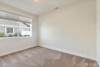 Perfect for guests, a home office, or creative space, this bright third bedroom adapts to your lifestyle needs.