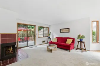 living room with new carpet and brick patio access