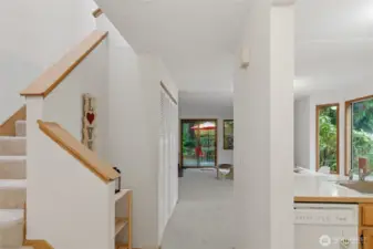 entry to stairs and kitchen with vaulted ceiling over the stairs