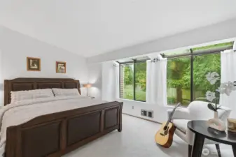 master bedroom with large windows and vaulted ceiling
