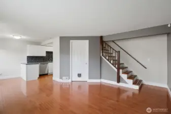 Upstairs leads to two generous bedrooms where hardwoods follow.
