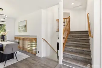 The upper stairs lead to the bedrooms and lower stairs take you to the family room.