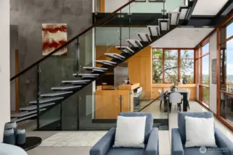 Acrylic cantilevered stair treads with glazed guards maintain openness and visual lightness