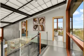 Daylight floods the home through a central translucent slot and floor-to-ceiling windows