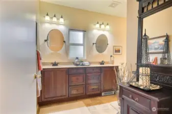 Remodeled spacious bathroom with dual sinks and walk-in shower.