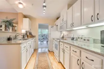Stunning kitchen with white cabinets, ample cabinet space, updated fixtures and lights. Kitchen has access to amazing 2nd bedroom/Family Room or Den.