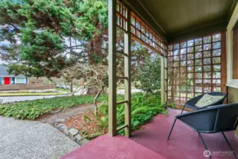 Protected from the weather, the front porch is a lovely place for morning coffee and a view of this quiet neighborhood.