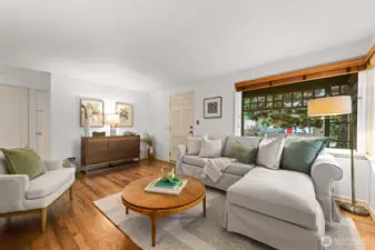 Beautiful hardwood floors, big windows with wood slatted shades and comfortable space for conversation, the living room.