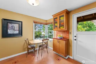 A perfect spot for the dining area overlooking the back yard. Glass front cabinets provide a vintage feel.