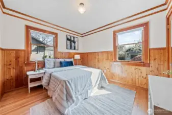 Bedroom #3: Warm and inviting, this charming room showcases rich wood wainscoting, multiple windows that fill the space with natural light, and plenty of room to relax, work, or unwind.