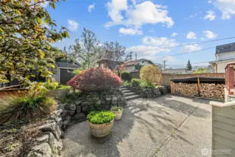 Enjoy the sunny patio surrounded by mature landscaping and a custom-built wood storage area, wood included with purchase —perfect for backyard entertaining or quiet mornings outside.