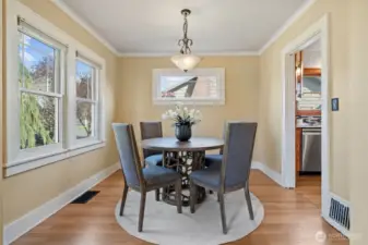This spacious dining room is filled with abundant natural light, thanks to period-matching Marvin double-pane windows. Designed with both charm and function in mind, it offers a warm, welcoming setting for everyday meals or entertaining. The open layout flows seamlessly into the living room and kitchen—perfect for connected, comfortable living.