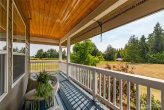 Large front porch looking out to expansive front lawn, over 2 acres.