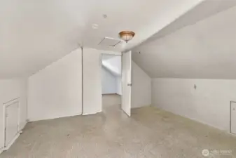 Upstairs room open to stairway. Door to bedroom.