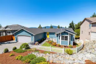 Fully fenced front yard with a picket fence and gate.