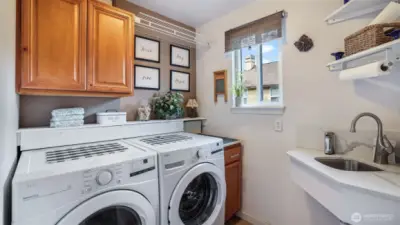 Ample storage and utility combine for a versatile and tidy laundry area.