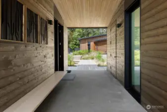 View of the breezeway which features a solid white oak, 24-foot-long wrap-through bench with under lighting.
