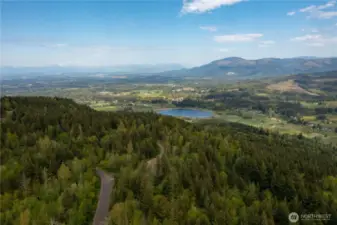 Aerial View looking at Squalicum Lake, Valley, with the Canadian Coastal Mountain range in the distance