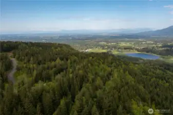 Aerial View looking at Squalicum Lake, Valley, with the Canadian Coastal Mountain range in the distance