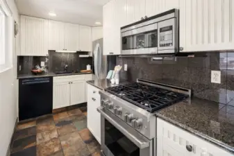 Cooks will love the stylish kitchen with slate floors, granite surfaces, and high-end stainless appliances including a Dacor Professional gas range and microwave.
