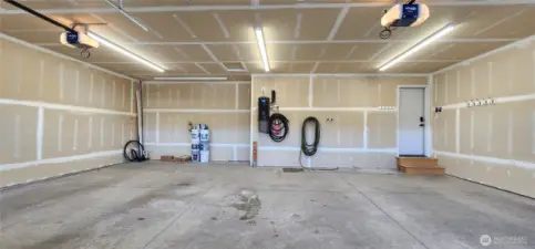 Expansive 3-car garage with storage hooks, central vacuum system for the whole house, and easy access to sprinkler system