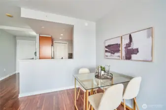 The dining area is adjacent to both the living room and kitchen and can fit a table for 4 or 6.