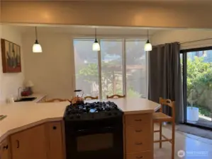 Angle of the kitchen looking toward the windows and sliding door.