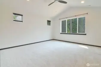 Primary bedroom with vaulted ceiling