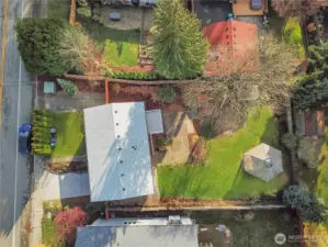 Aerial view showcasing the home, expansive backyard, and detached artist’s studio—offering incredible space and versatility.
