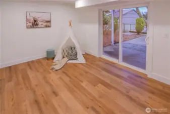 Large lower-level bedroom with sliding door access to the backyard—ideal as a guest room, teen suite, or flexible bonus space.
