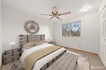 Bedroom Two features soft neutral tones, plush carpeting, and a large window that fills the space with natural light. The layout offers comfort and flexibility for your ideal bedroom design.