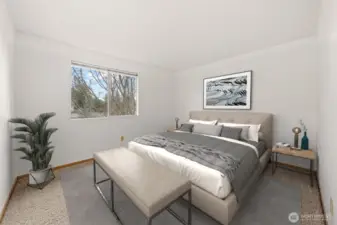 Bedroom Three features a serene view through the large window, creating a peaceful and inviting atmosphere. Plush carpeting adds warmth and comfort, consistent with the home’s beautifully appointed bedrooms.