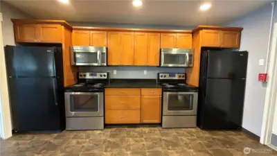 A thoughtfully designed clubhouse kitchen offering generous storage, full-size appliances, and a functional layout perfect for gatherings.