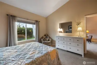 Main floor primary suite with view of greenspace.