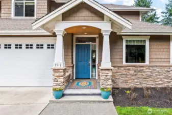 Inviting covered front porch welcomes you to this end-unit townhome-style condo in Cherry Lane Estates, offering a private entrance and peaceful Gig Harbor setting.