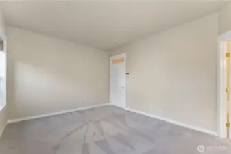 Main floor master bedroom. Photo depicts the room without furniture; seller furnishings are currently in the home.