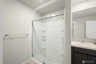 Primary bedroom features a double vanity, walking shower, and huge walk-in closet