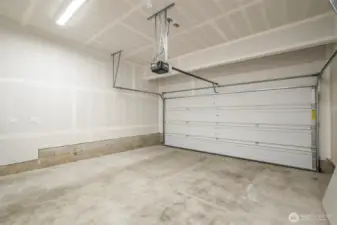 Large 2 car garage with plenty of overhead space for storage solutions.