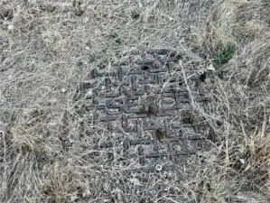 On the eastern boundary, there is this sewer lid. Refer to title report to understand the easements for this property.