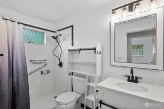 Updated bathroom w/ step in shower, new vanity and vinyl tile floor.