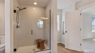 This shower is gorgeous with the glass/tile surround, rain shower head and heated towel rack.