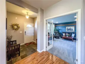 Welcoming entryway which opens into the formal living room complete with double french doors.