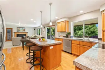 Kitchen with newer stainless-steel appliances flows into the family room