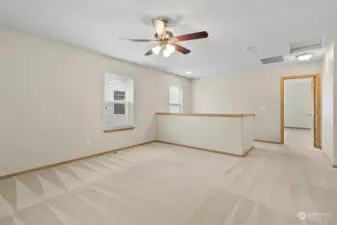 Upstairs Bonus / Loft Area with Ceiling Fan (1 of 3 in the home). Located off the Primary Bedroom and Separates the Floorplan from the Other Bedrooms and Full Bath. Upstairs Laundry in the Hallway Not Pictured