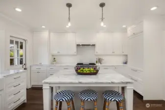 Custom wood-clad casement windows open to the backyard, Dutch door opens to deck with piped natural gas for barbecue.