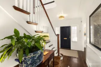 Level entry from front yard to open center hall, impressive staircase with original single-width mahogany stair treads.